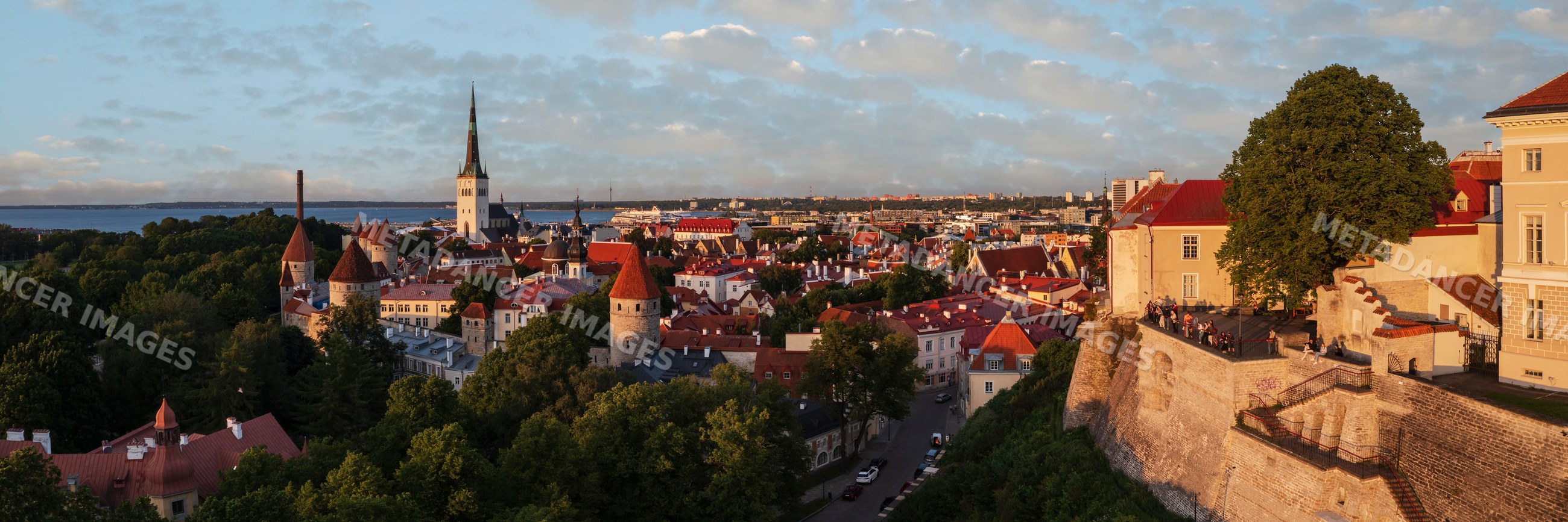 Tallinn skyline at sunset with historic fortress and church steeple