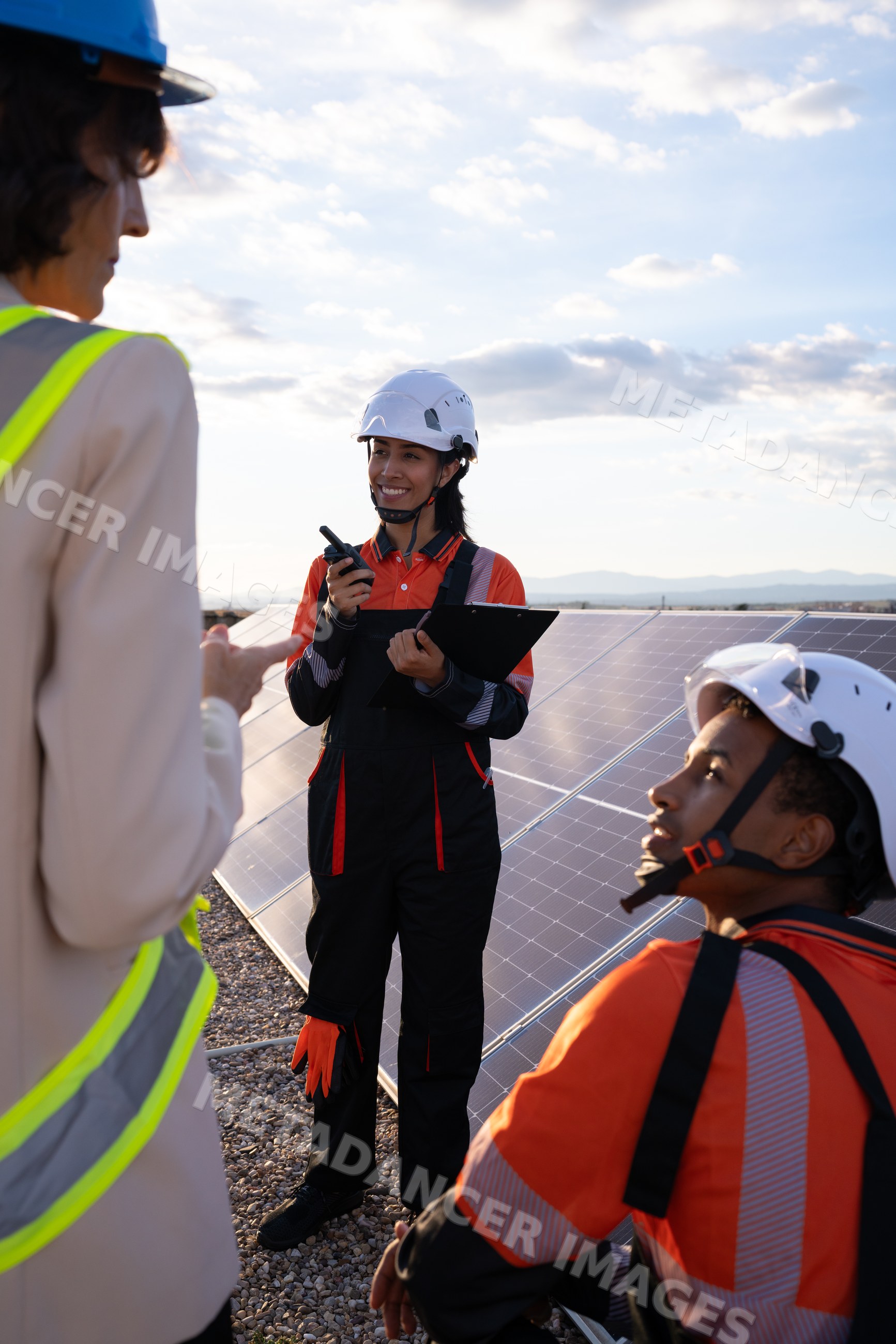 Solar energy Hispanic and white workers inspecting solar panels