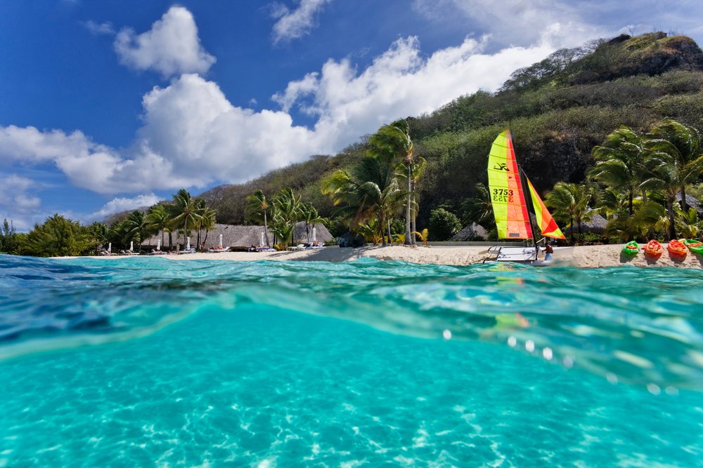 Sailboat and kayaks on tropical beach