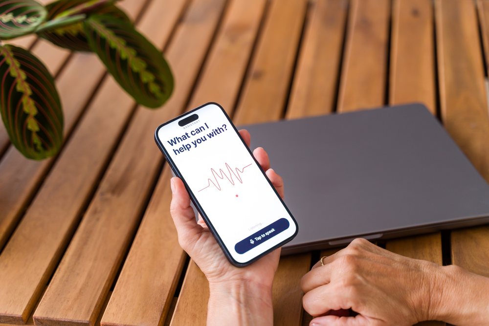 Smartphone with voice assistant app on wooden table