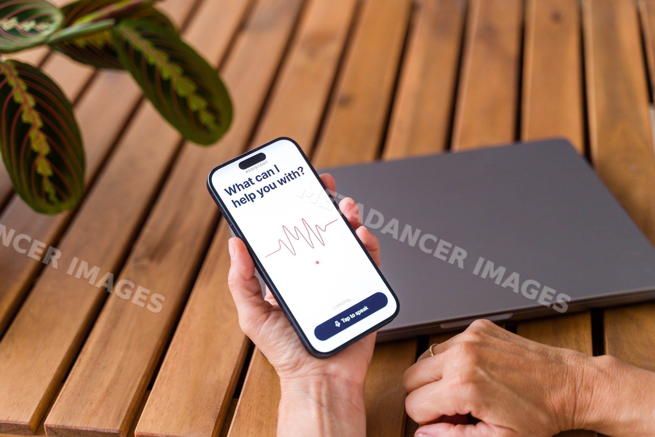 Smartphone with voice assistant app on wooden table