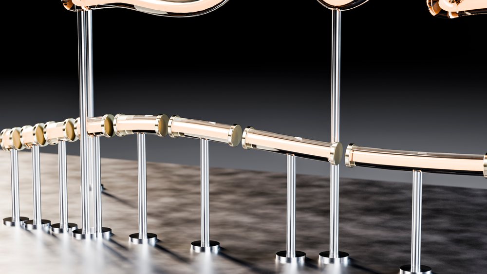 Curved polished metal handrail with vertical supports