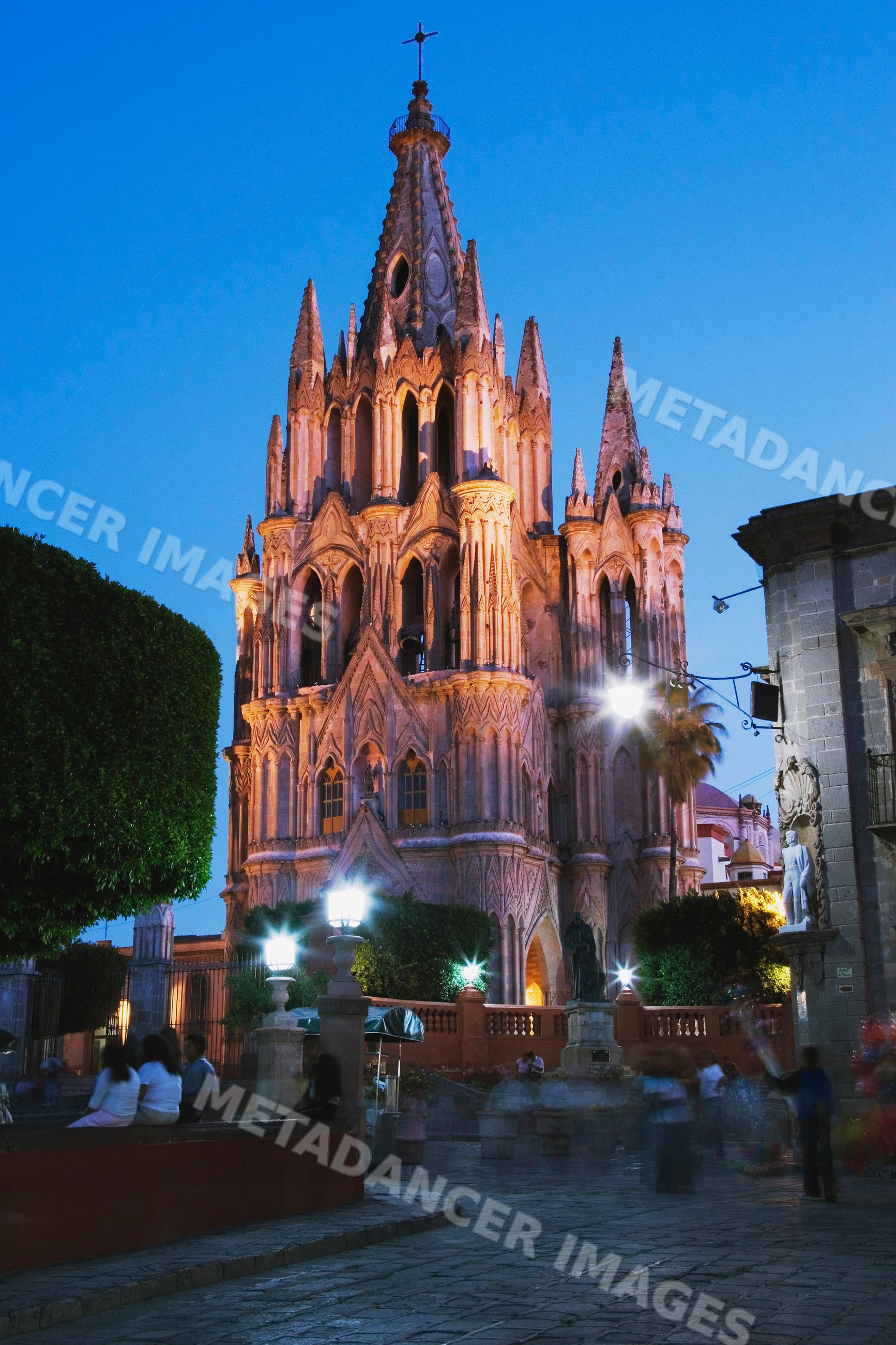 Gothic-style church illuminated at evening plaza