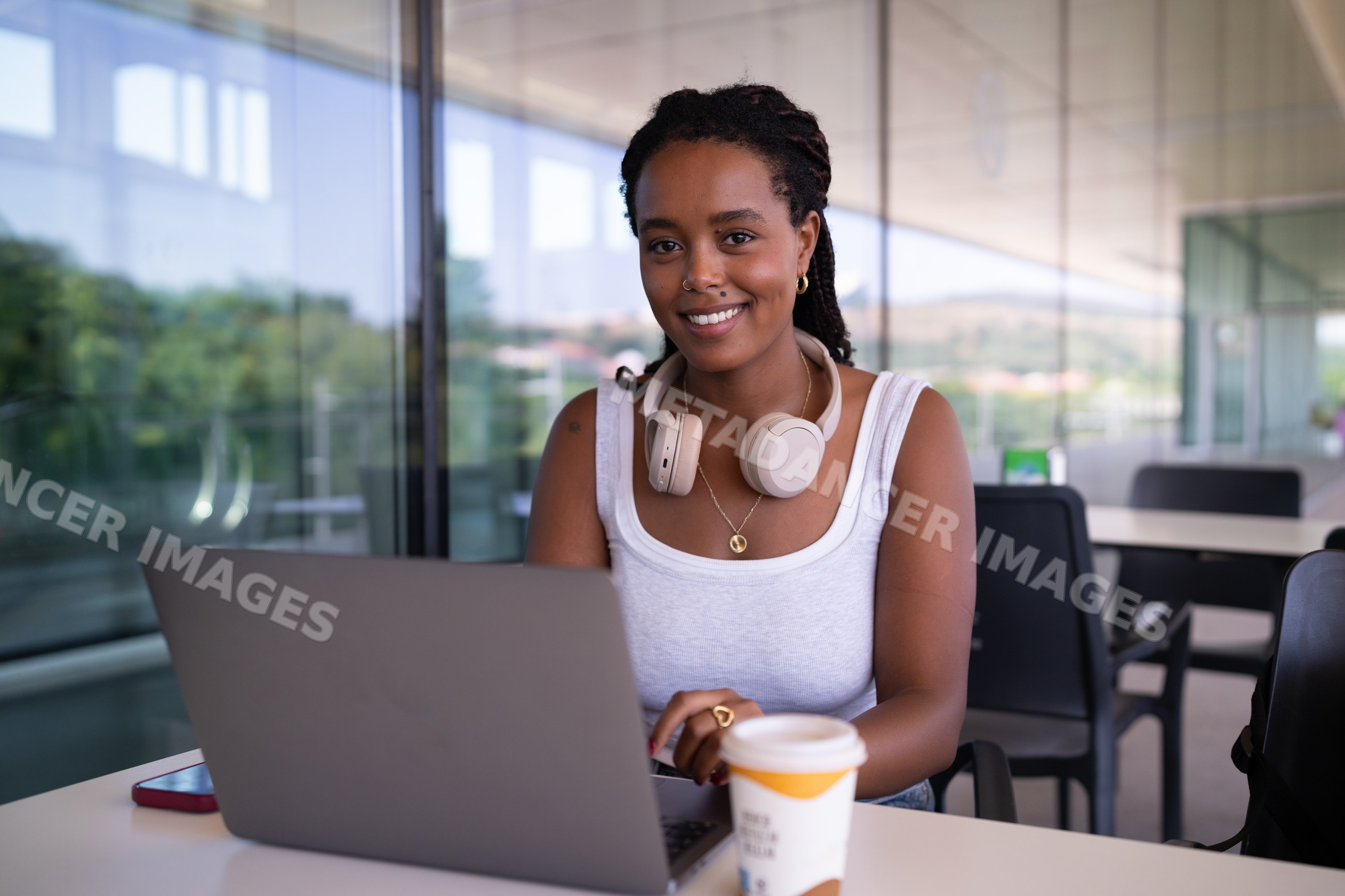 A young African American woman working remotely on her laptop