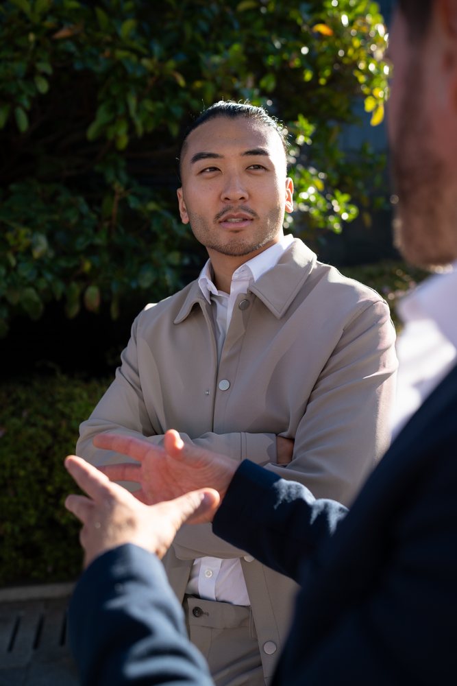 White man attentively listening during outdoor conversation