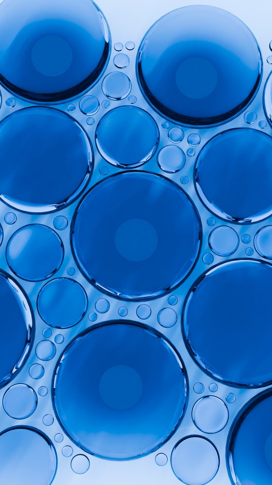 Blue liquid bubbles macro close-up with abstract circular patterns