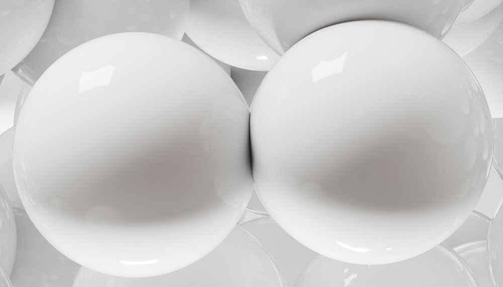Close-up of smooth white glossy spheres clustered