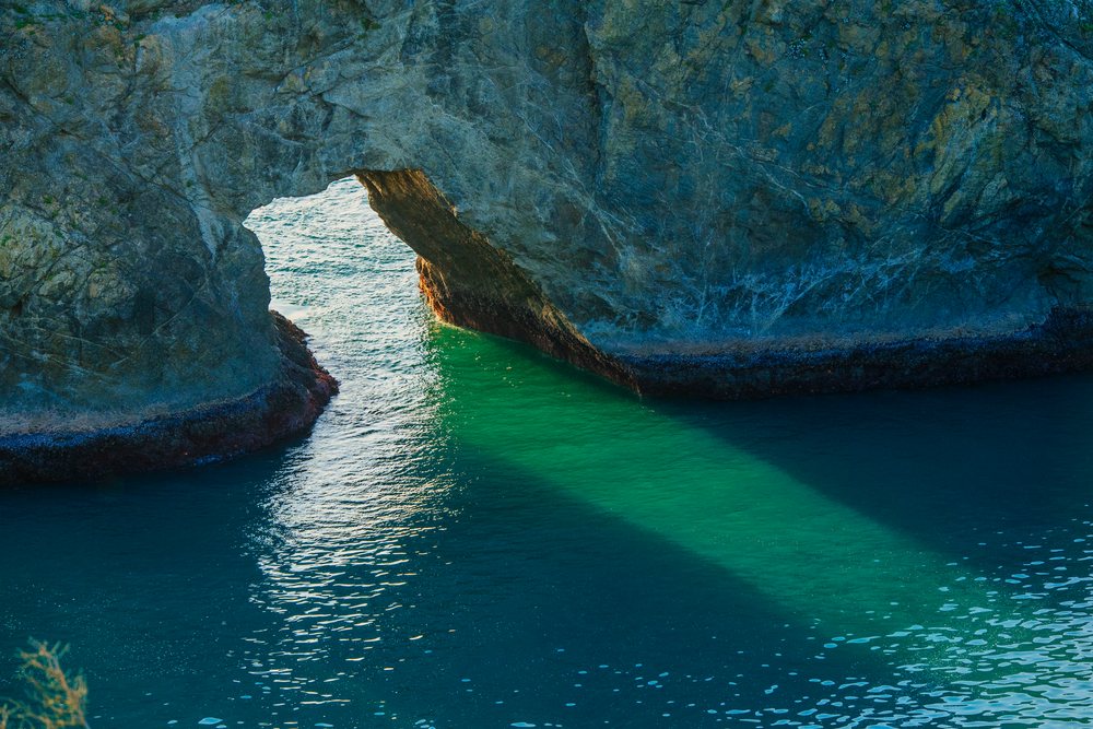 Natural rock arch formation over ocean Oregon