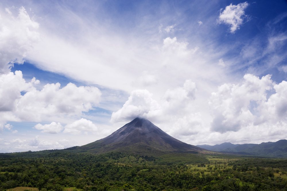 Arenal volcano rises above tropical forest landscape, costa rica
