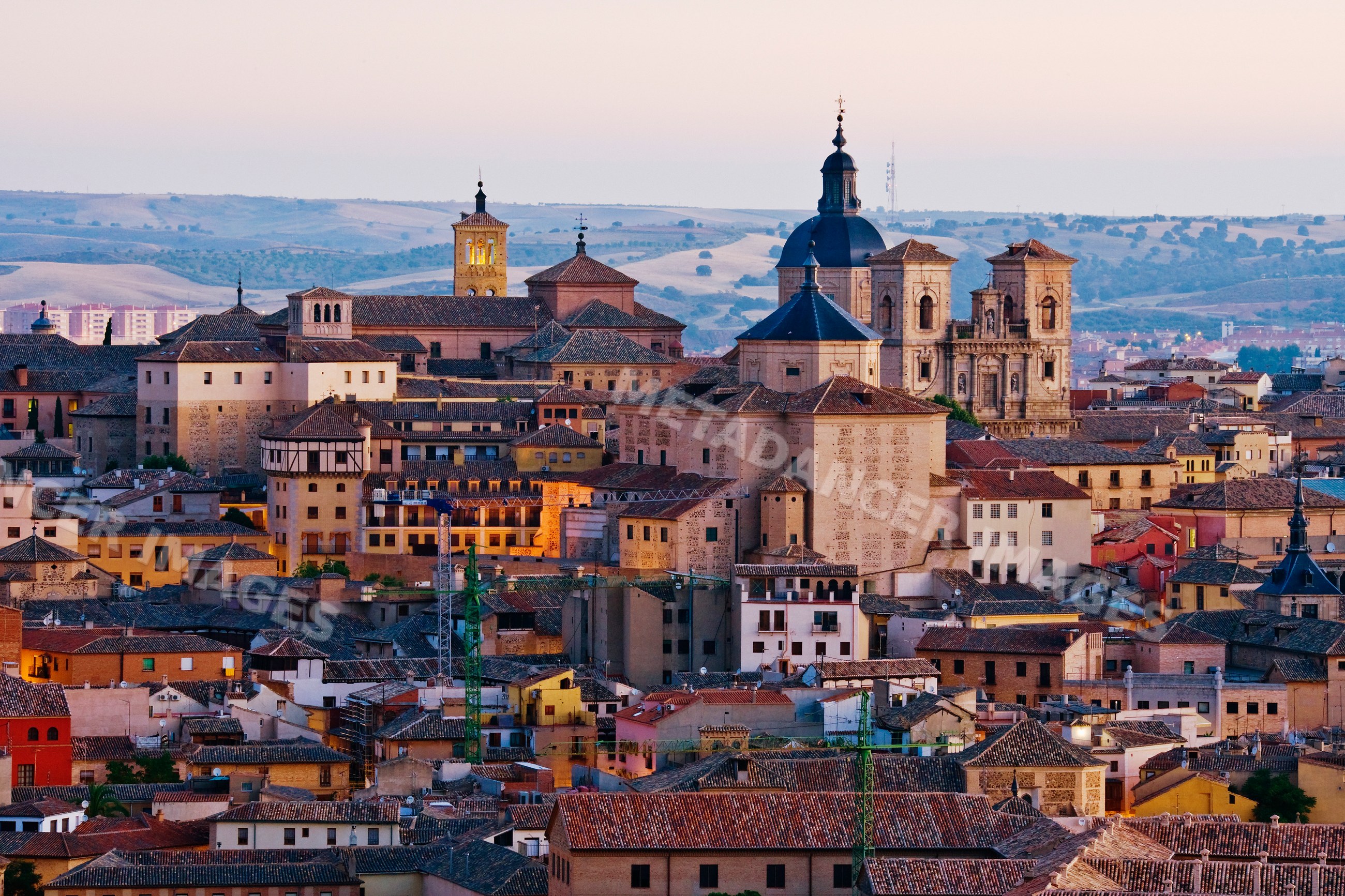 Cityscape of historic toledo with church towers at twilight