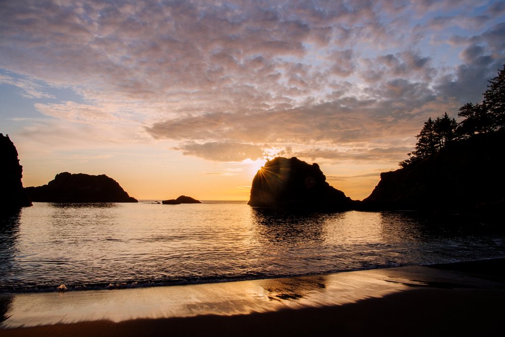 Sunset over ocean and rock formations