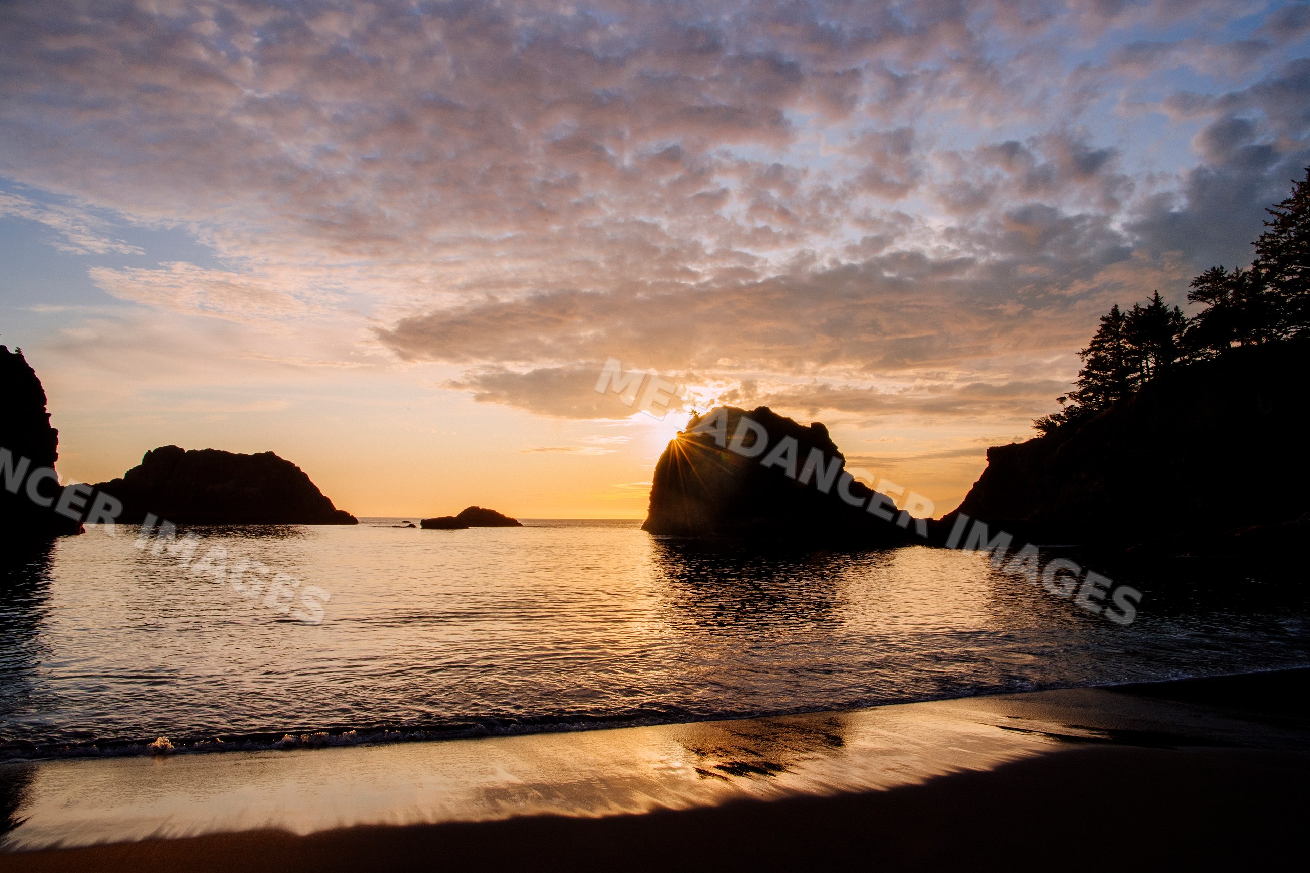 Sunset over ocean and rock formations