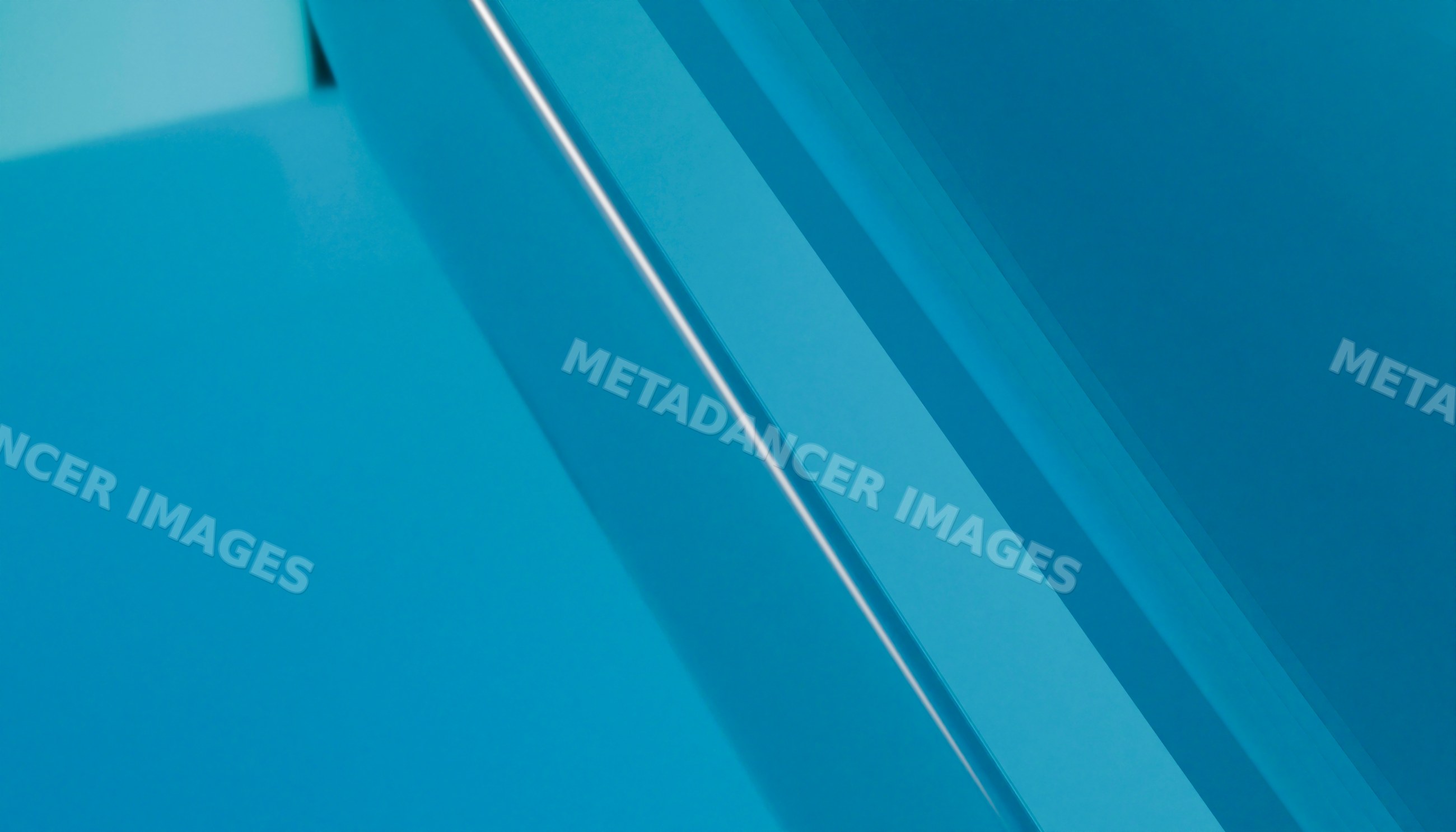 Close-up of layered blue glass showing abstract geometric reflections
