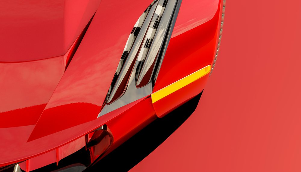 Close-up of the front hood and headlight assembly of a red vehicle