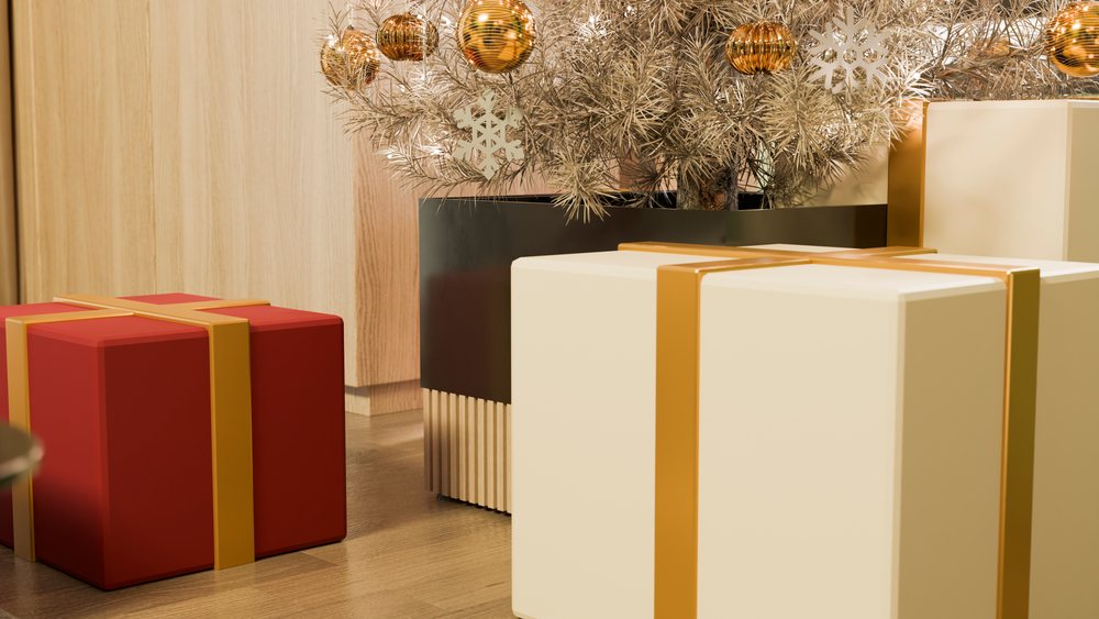 Christmas presents with gold ribbons under decorative tree