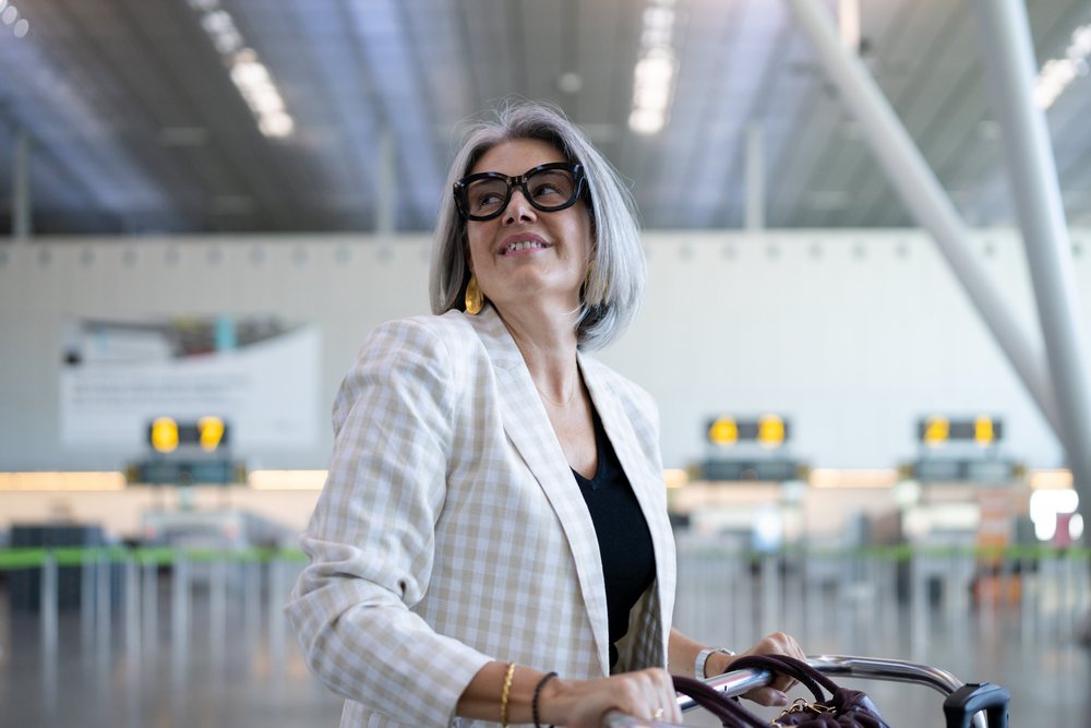 Businesswoman traveler sitting in a wheelchair at airport terminal