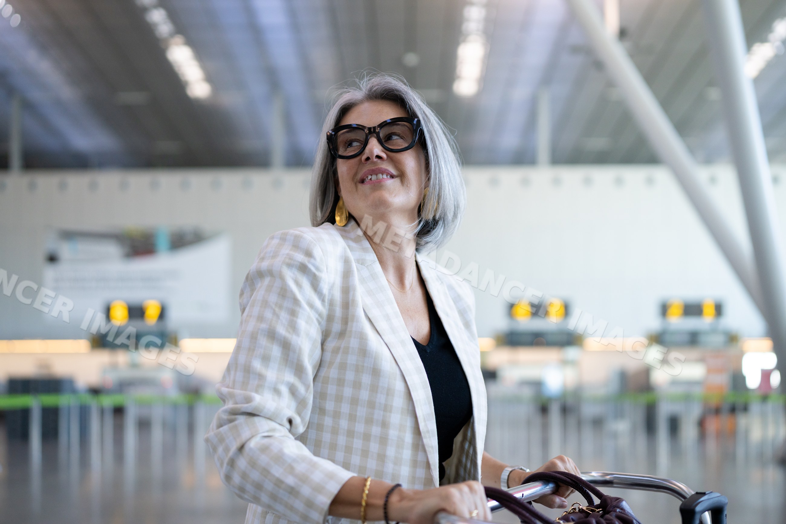 Businesswoman traveler sitting in a wheelchair at airport terminal