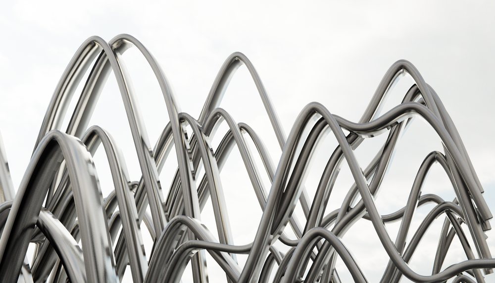 Abstract metal sculpture of curved steel tubes creating interwoven