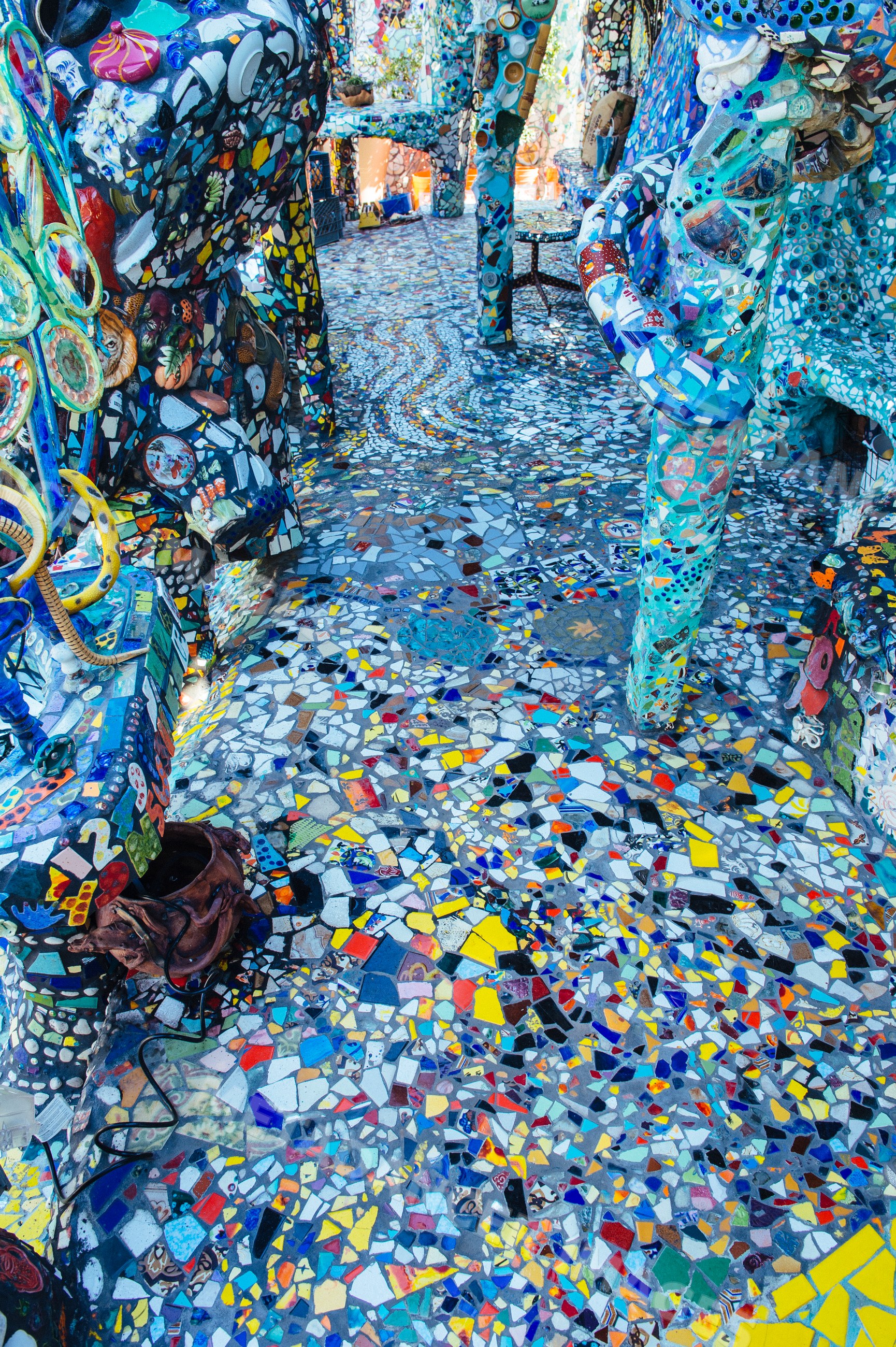 Colorful mosaic sculpture with decorative tiled walkway