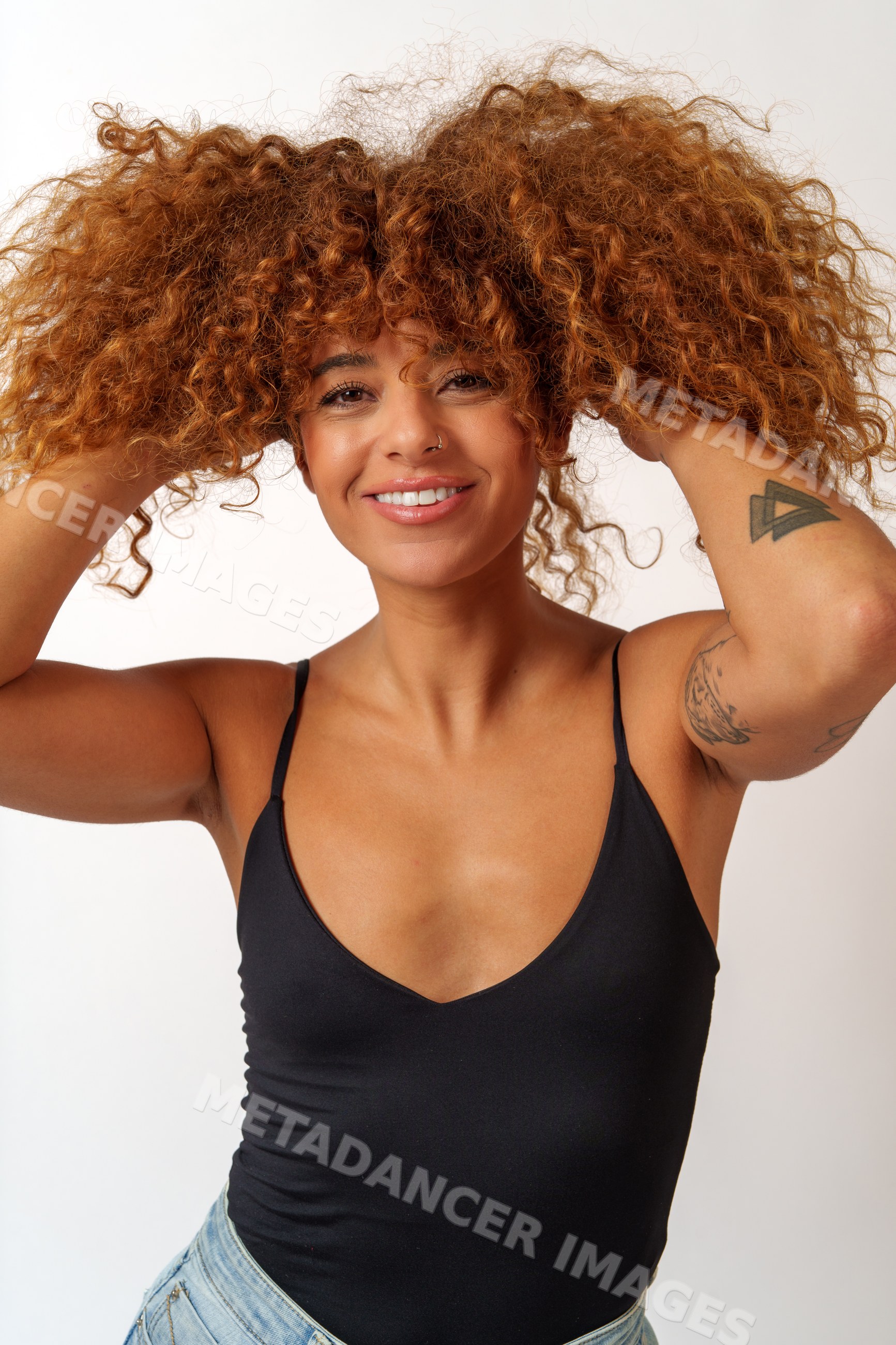 Hispanic woman smiling with curly red hair in studio in Malaga, Spain