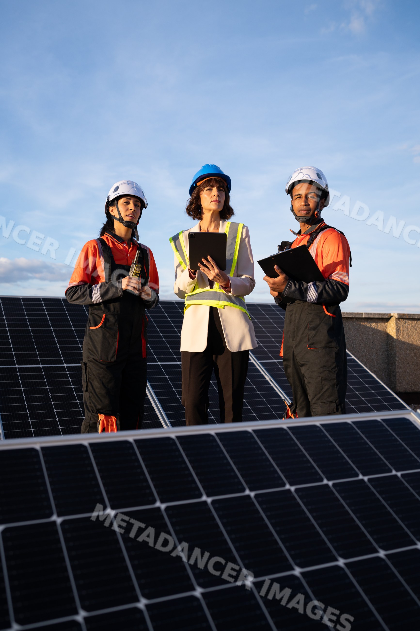 Engineers inspecting solar panels outdoors in Madrid, Spain