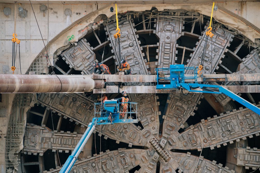 Construction workers operating a tunnel boring machine