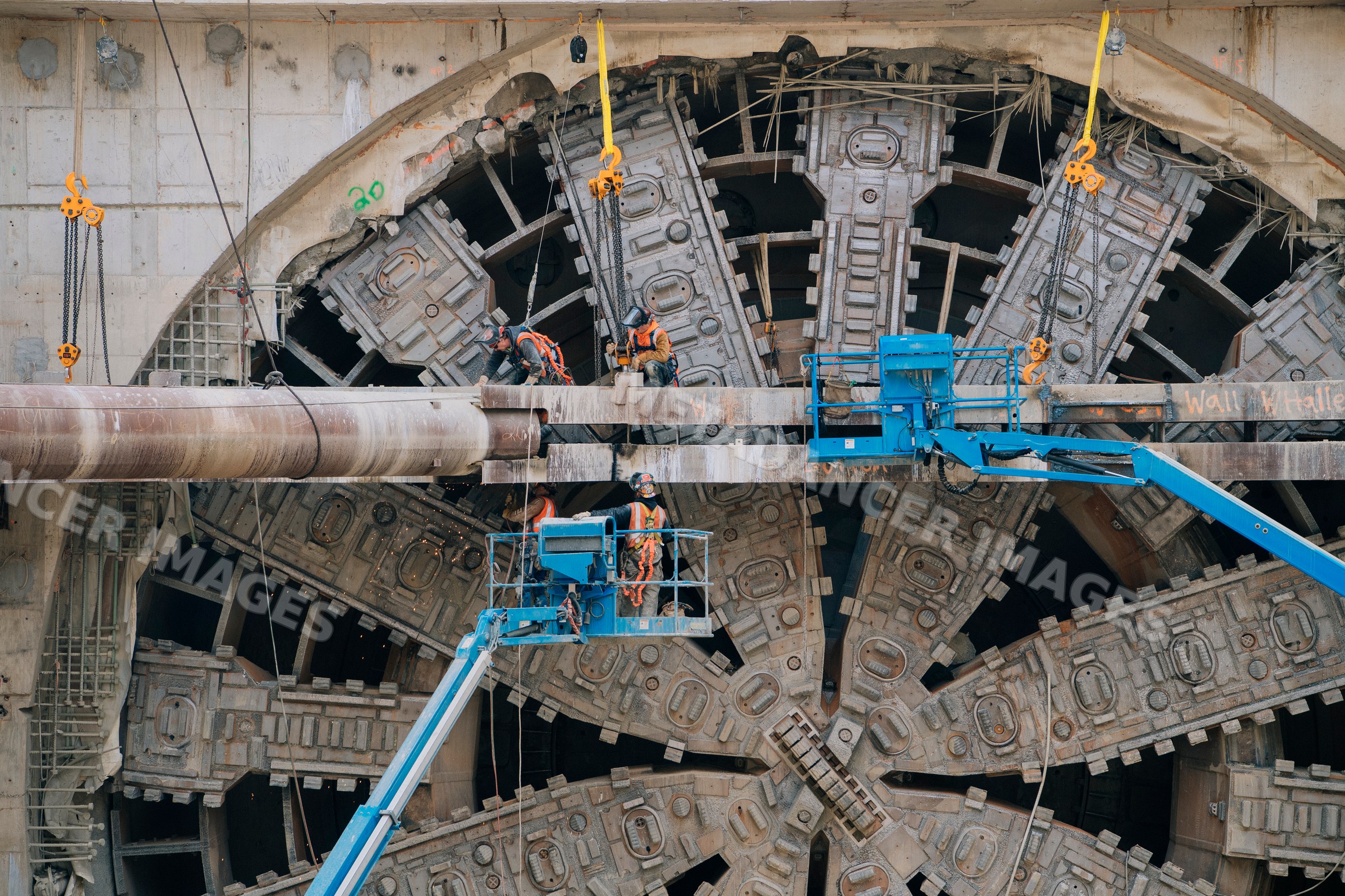Construction workers operating a tunnel boring machine