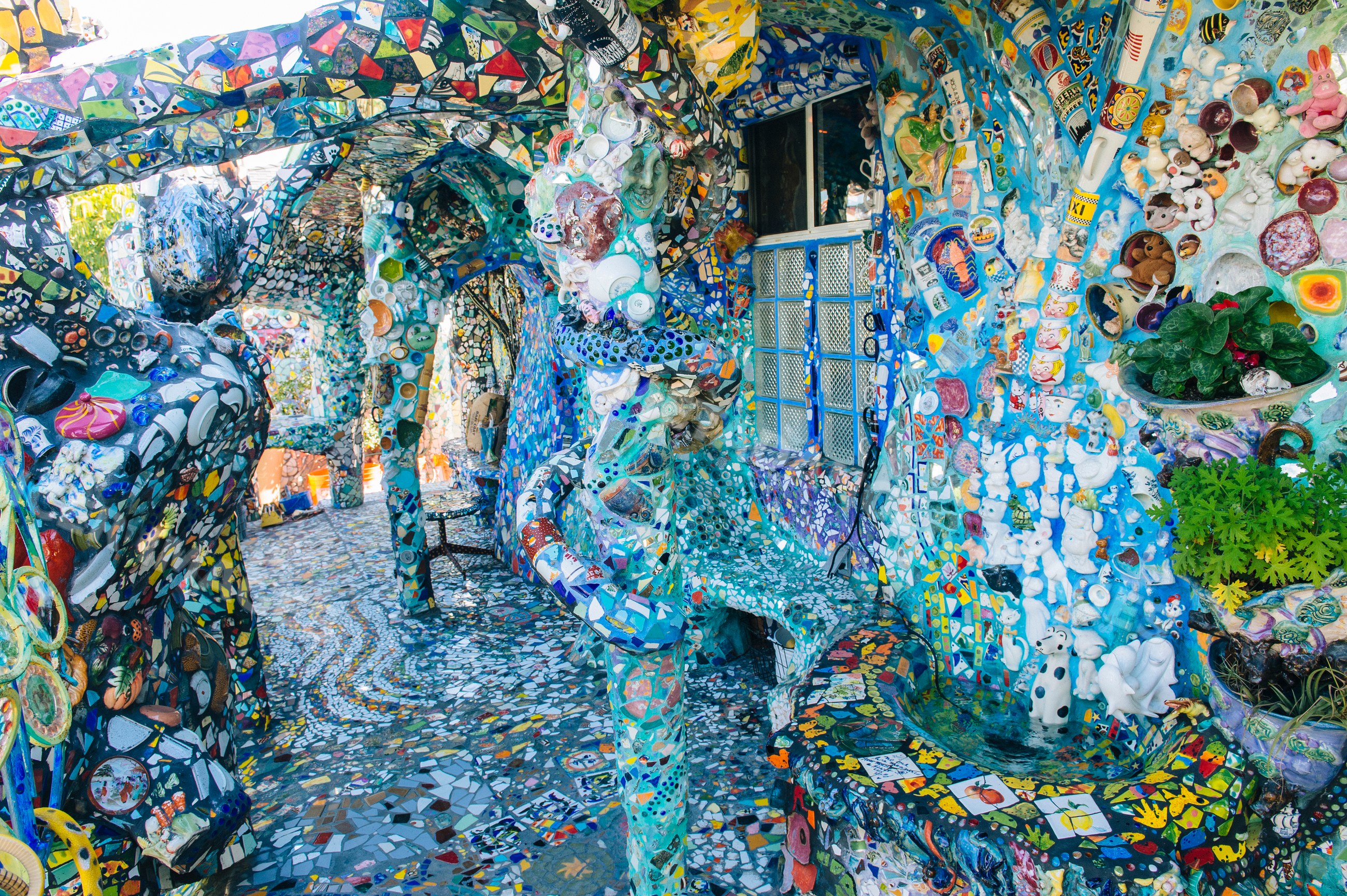 Colorful mosaic art installation with decorated columns and walls