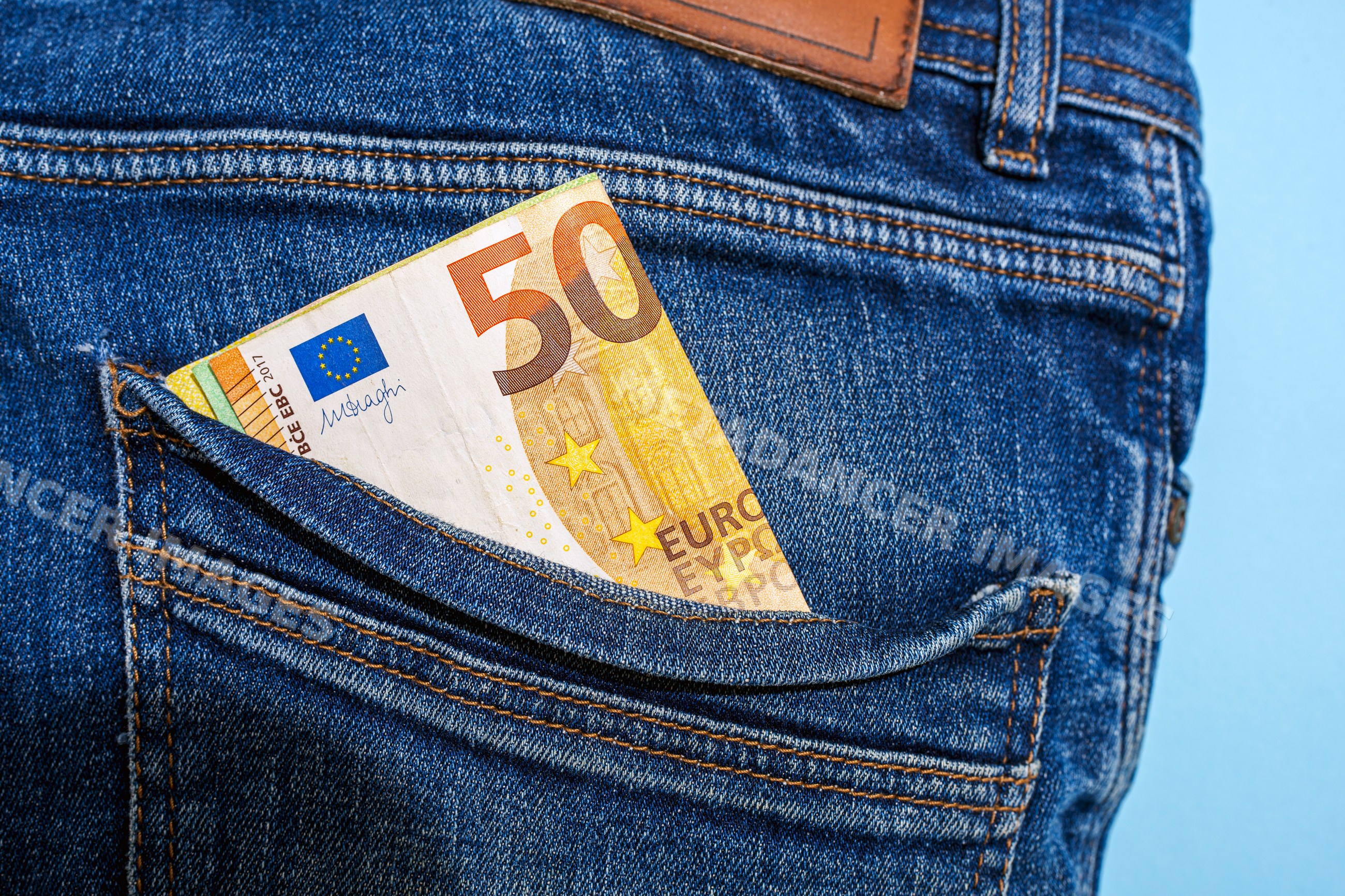 50 euro banknote in back pocket of blue denim jeans