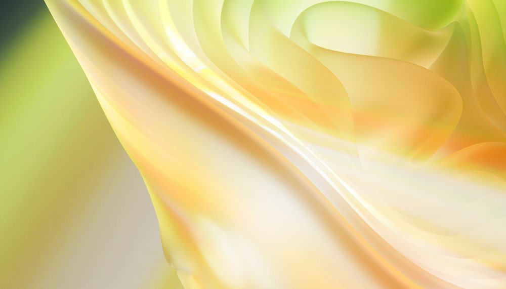 Close-up of flowing fabric with smooth soft folds and light yellow