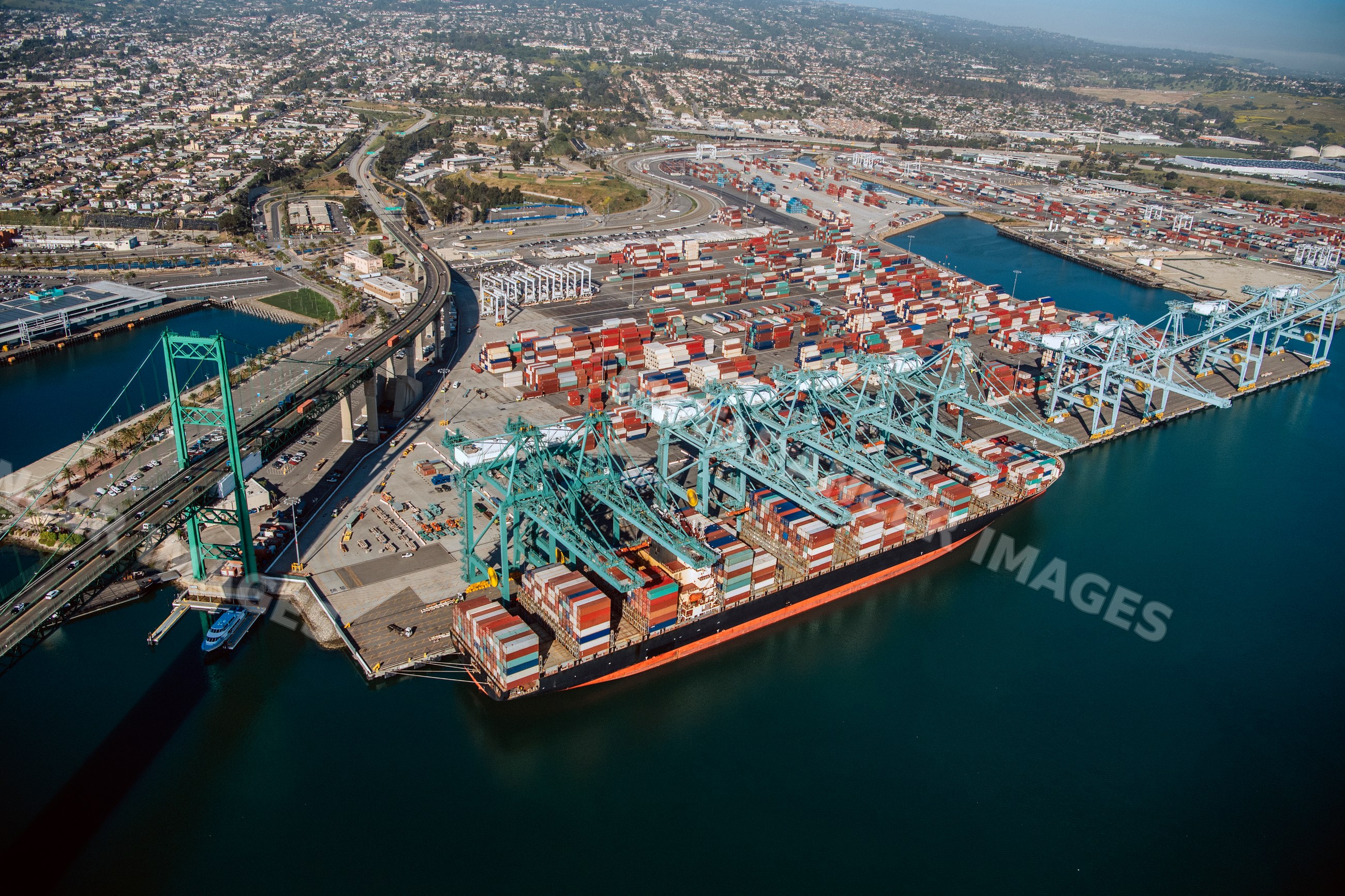 Container ship unloading shipping containers in a beach
