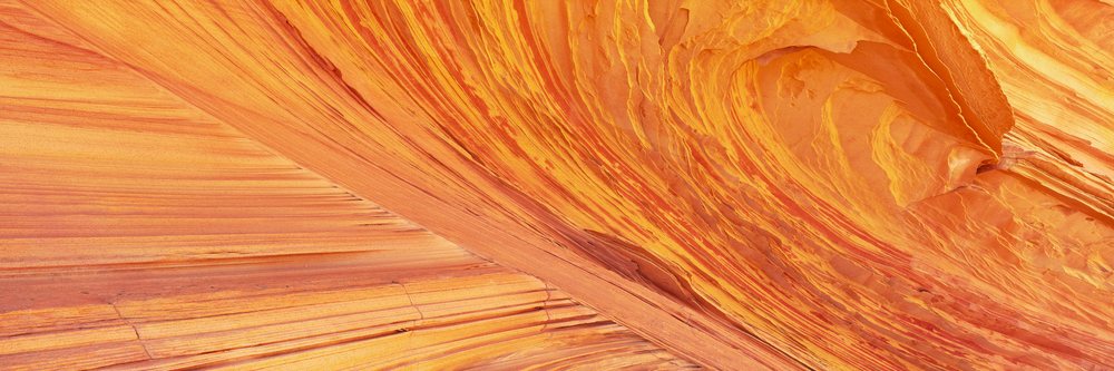 Orange sandstone layered rock formations with natural erosion