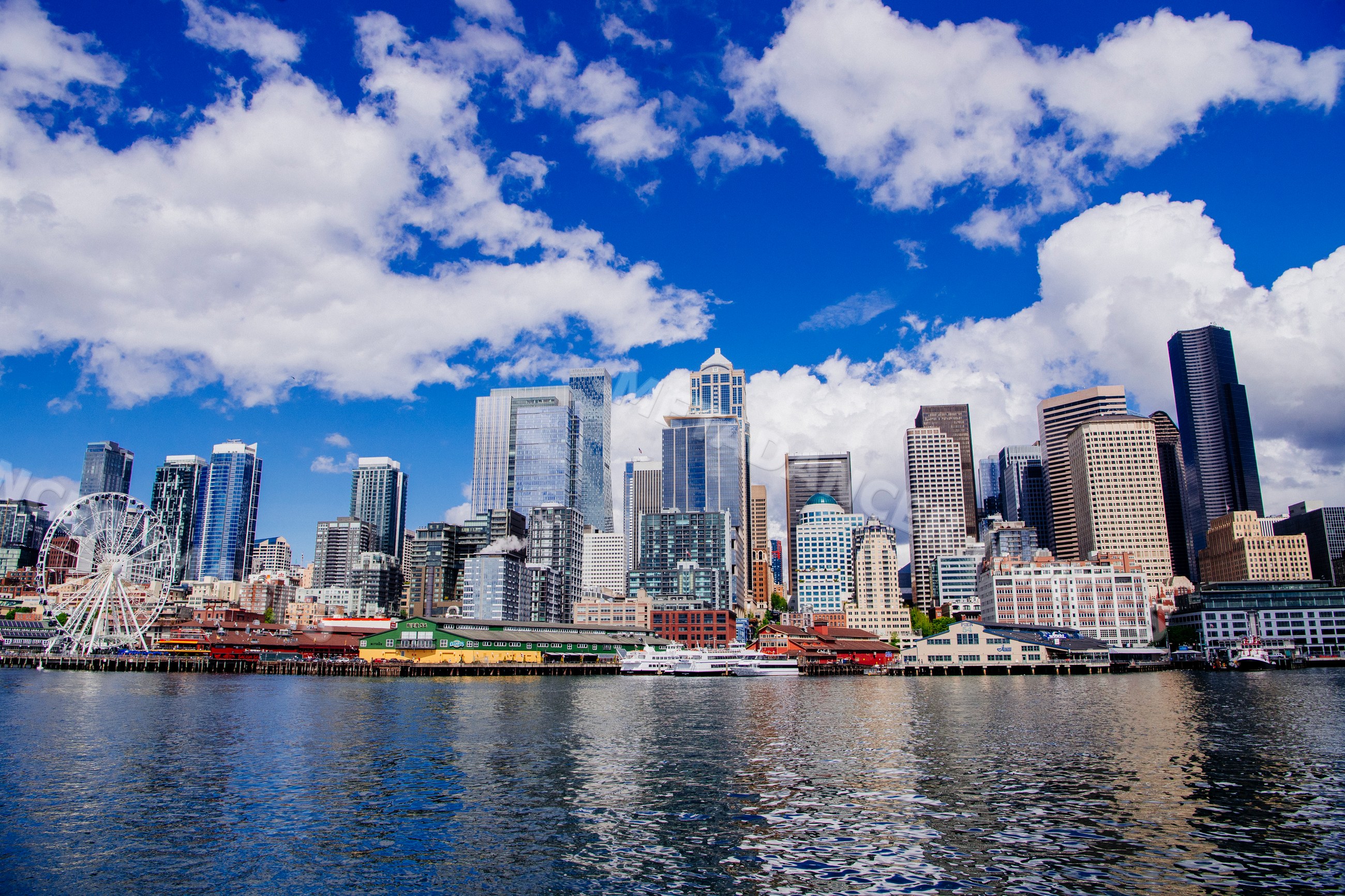 Seattle waterfront skyline with ferris wheel and blue sky