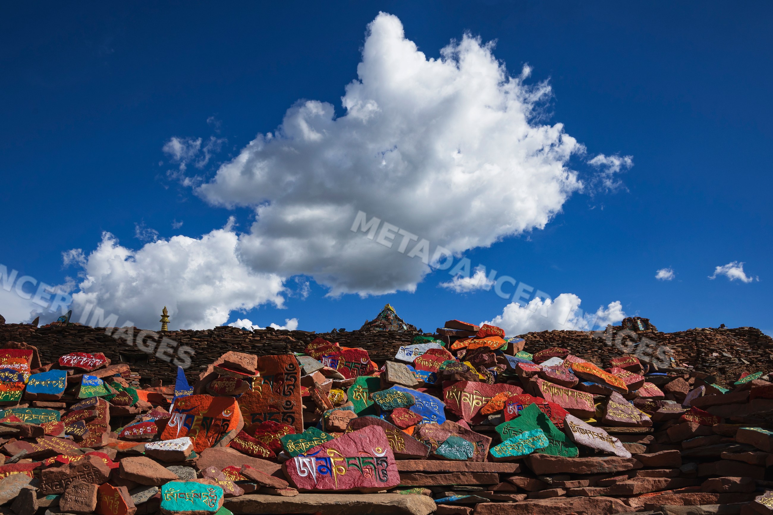 Mani Wall of painted prayer stones in Kham Tibet sichuan province