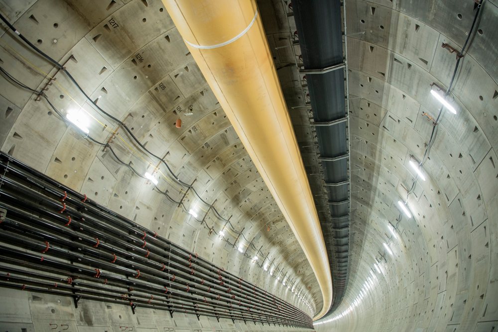 Inside a large round industrial tunnel with ventilation ducts