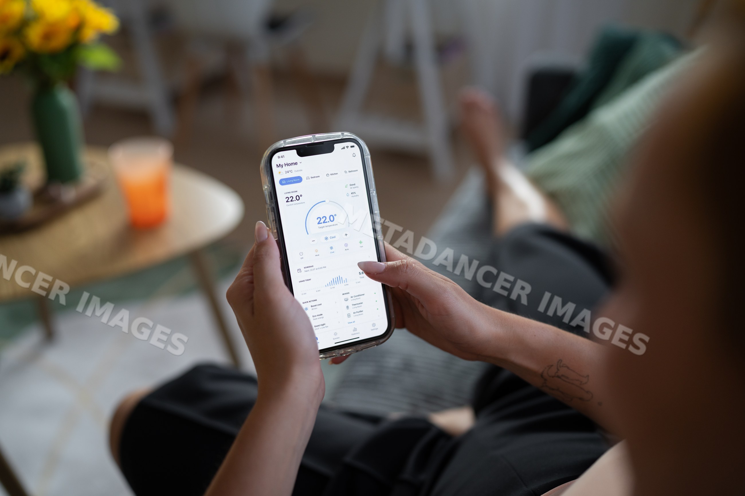 White Person adjusting home temperature with mobile app in living room