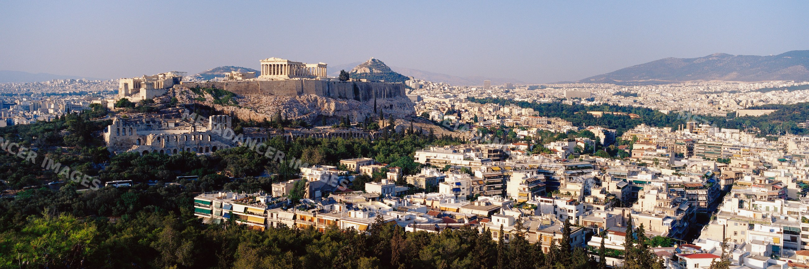 Acropolis ancient ruins overlooking urban athens cityscape greece