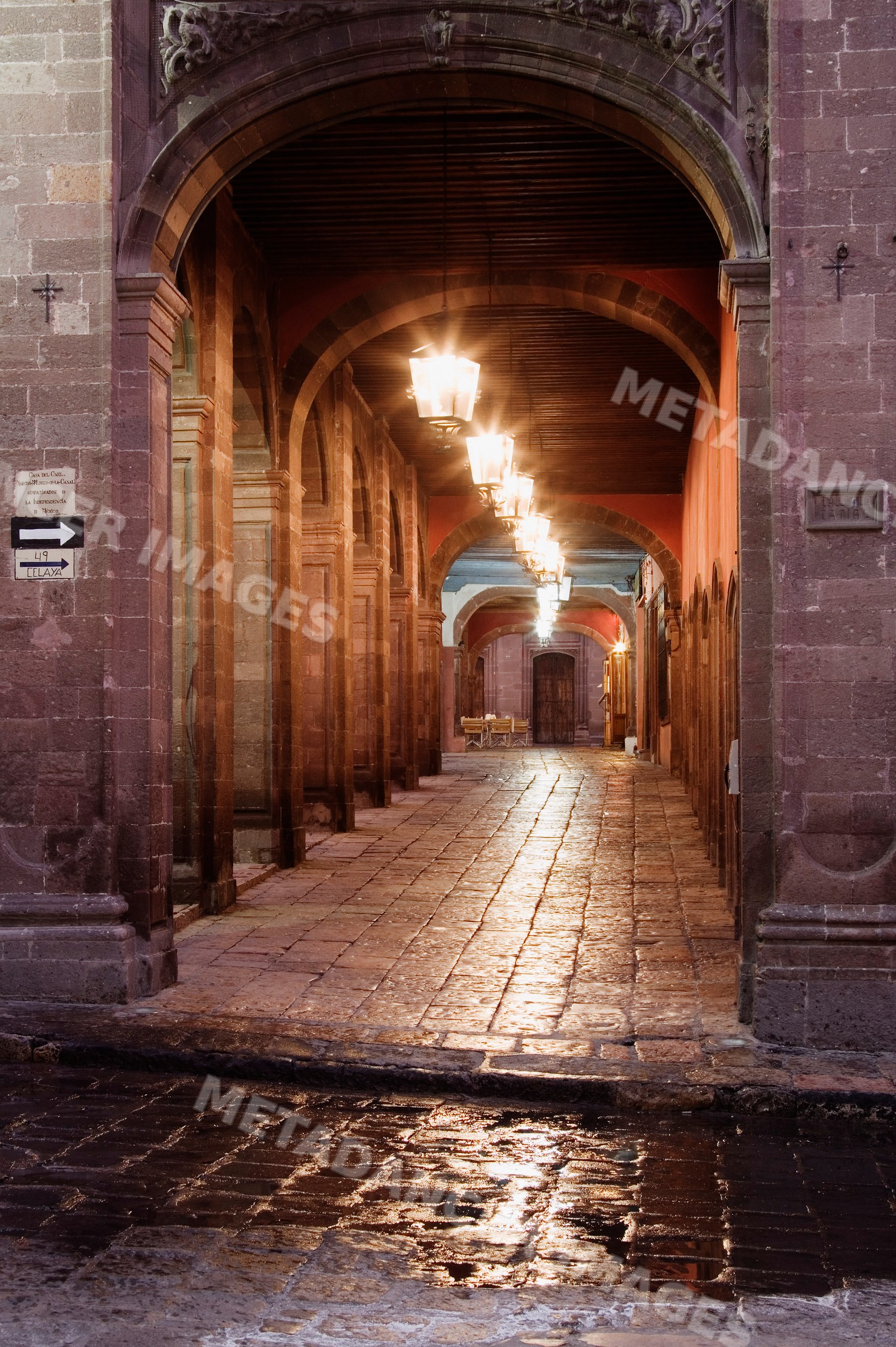 Walkway under arches with lantern lights, mexico