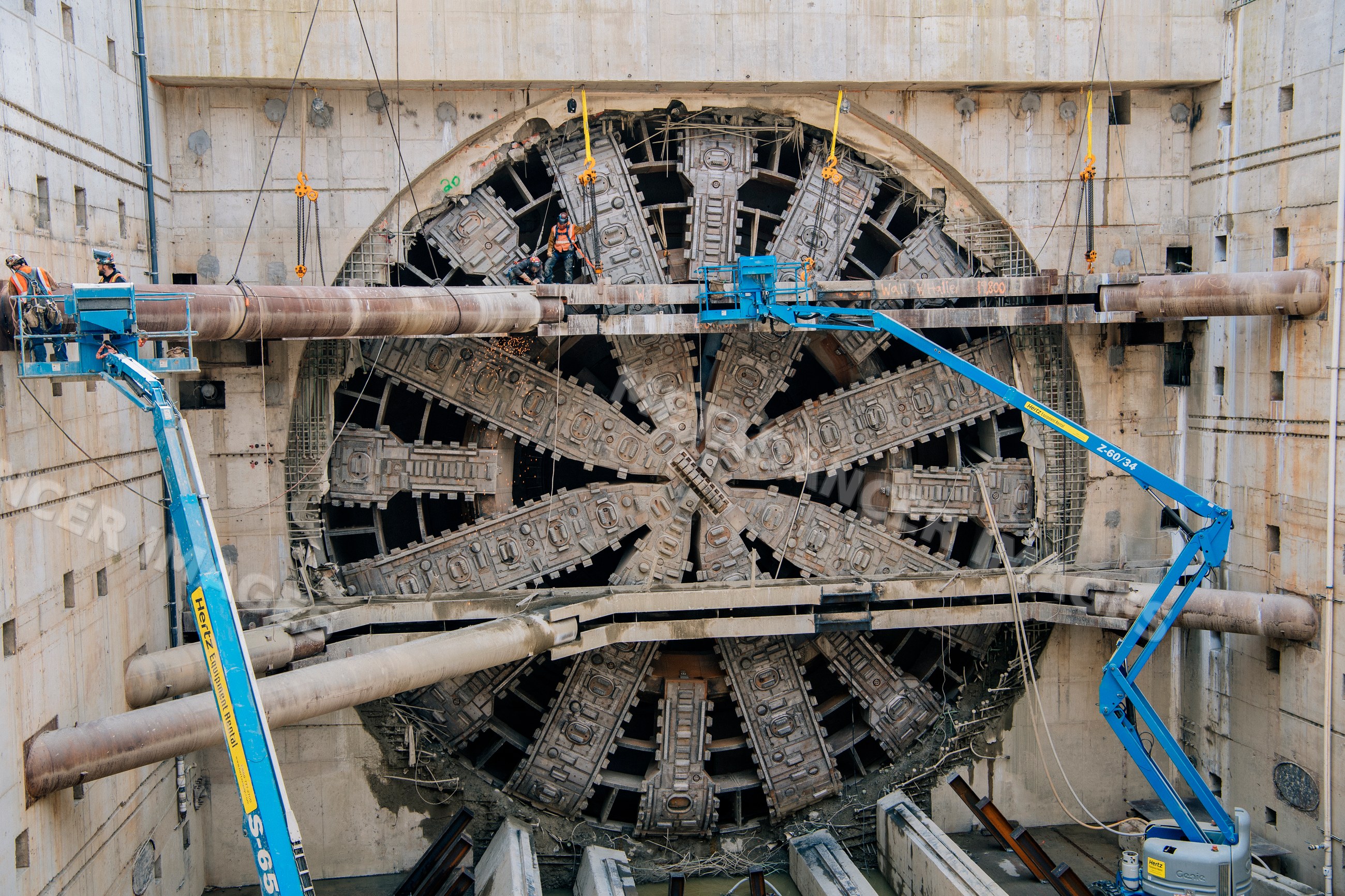 A tunnel boring machine undergoing maintenance at a construction site