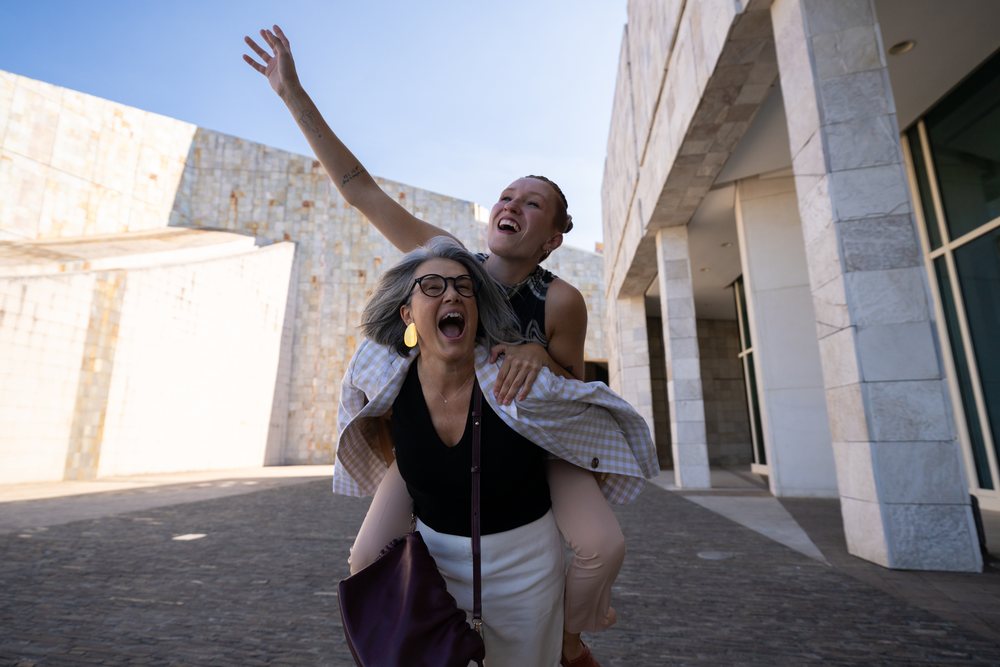 White women sharing joyful piggyback moment outdoors