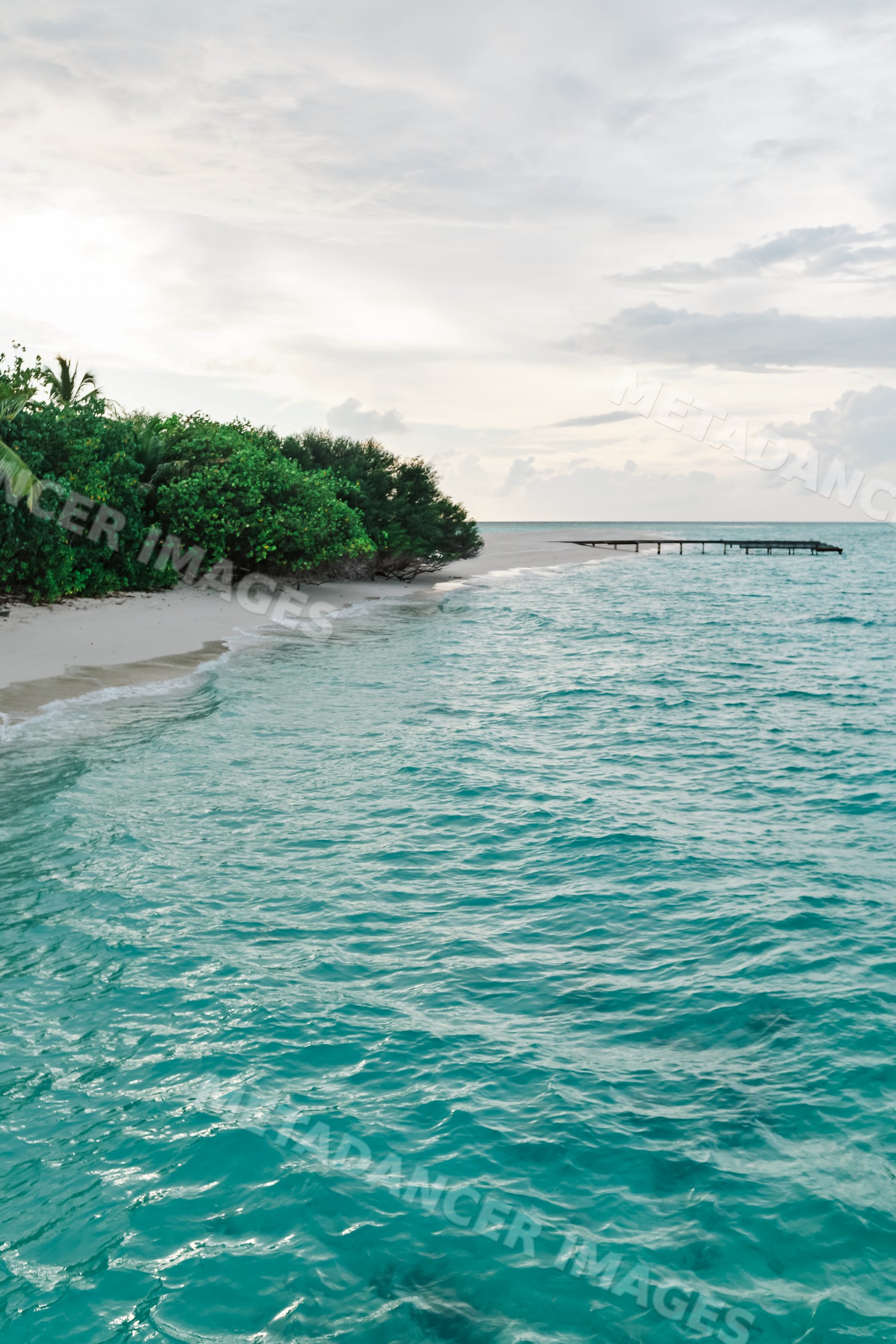A tropical island beach with a pier in a beach