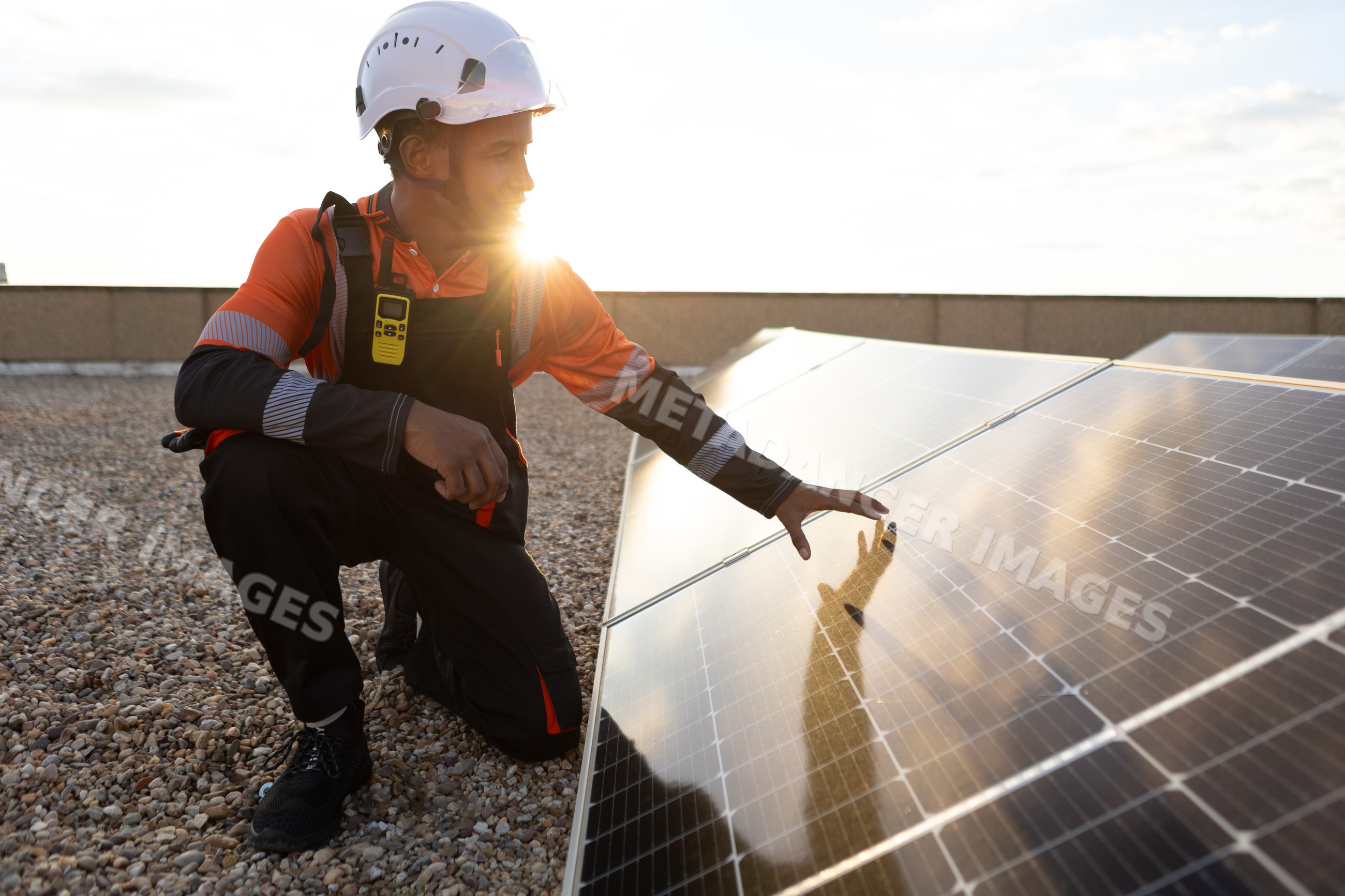 Man inspecting solar panels for renewable energy outdoors