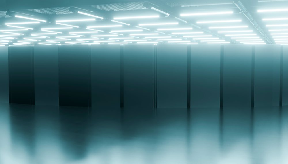 Server racks in a modern data center with bright fluorescent ceiling