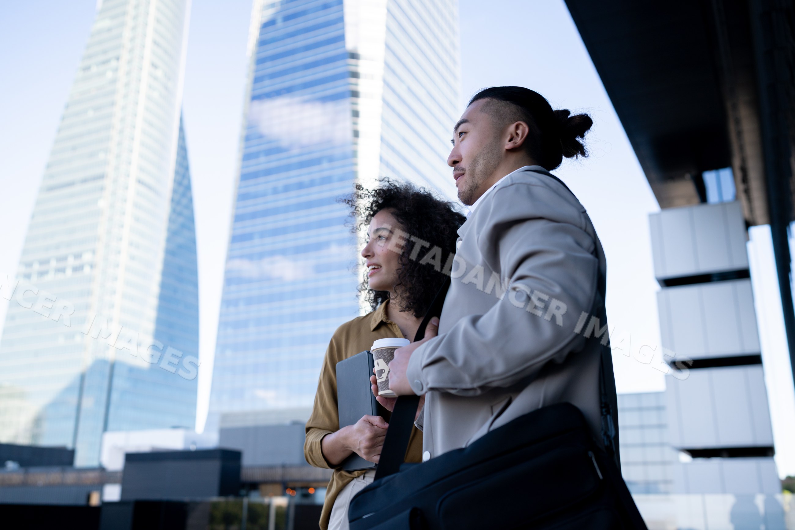 Businessman and businesswoman with coffee and tablet