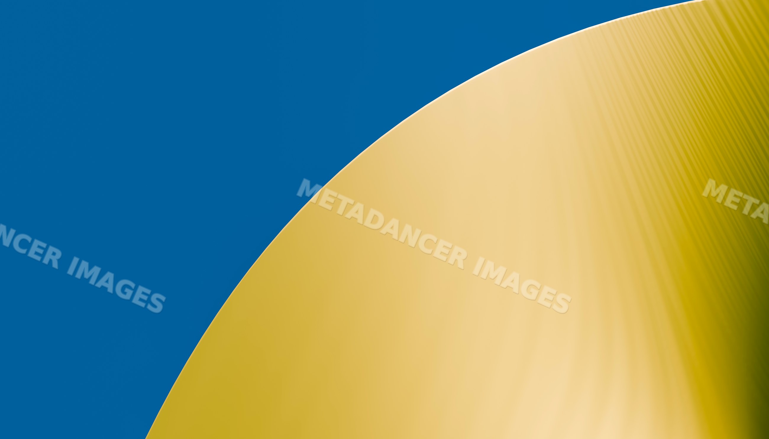 Golden curved metallic surface with blue background