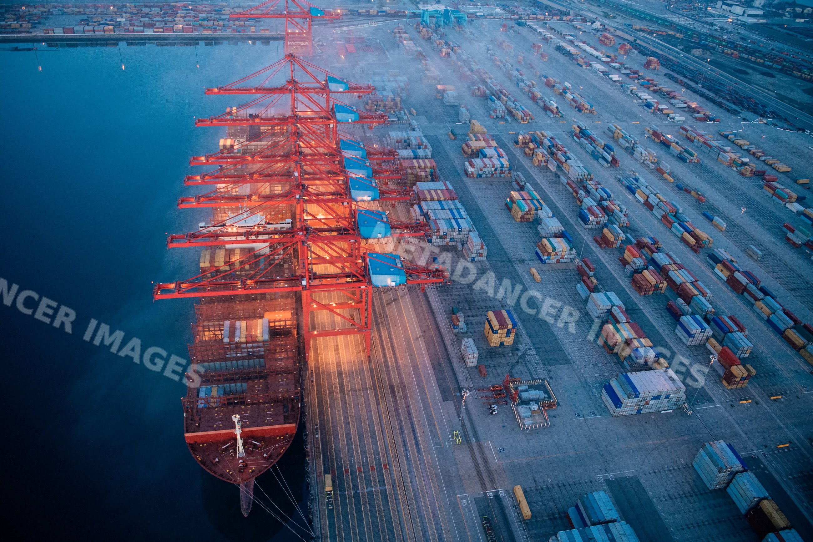 Container ship loading at cargo cranes in the Port of Long Beach port