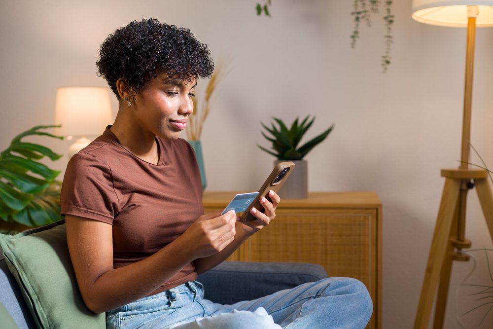Young African American woman shopping online with credit card