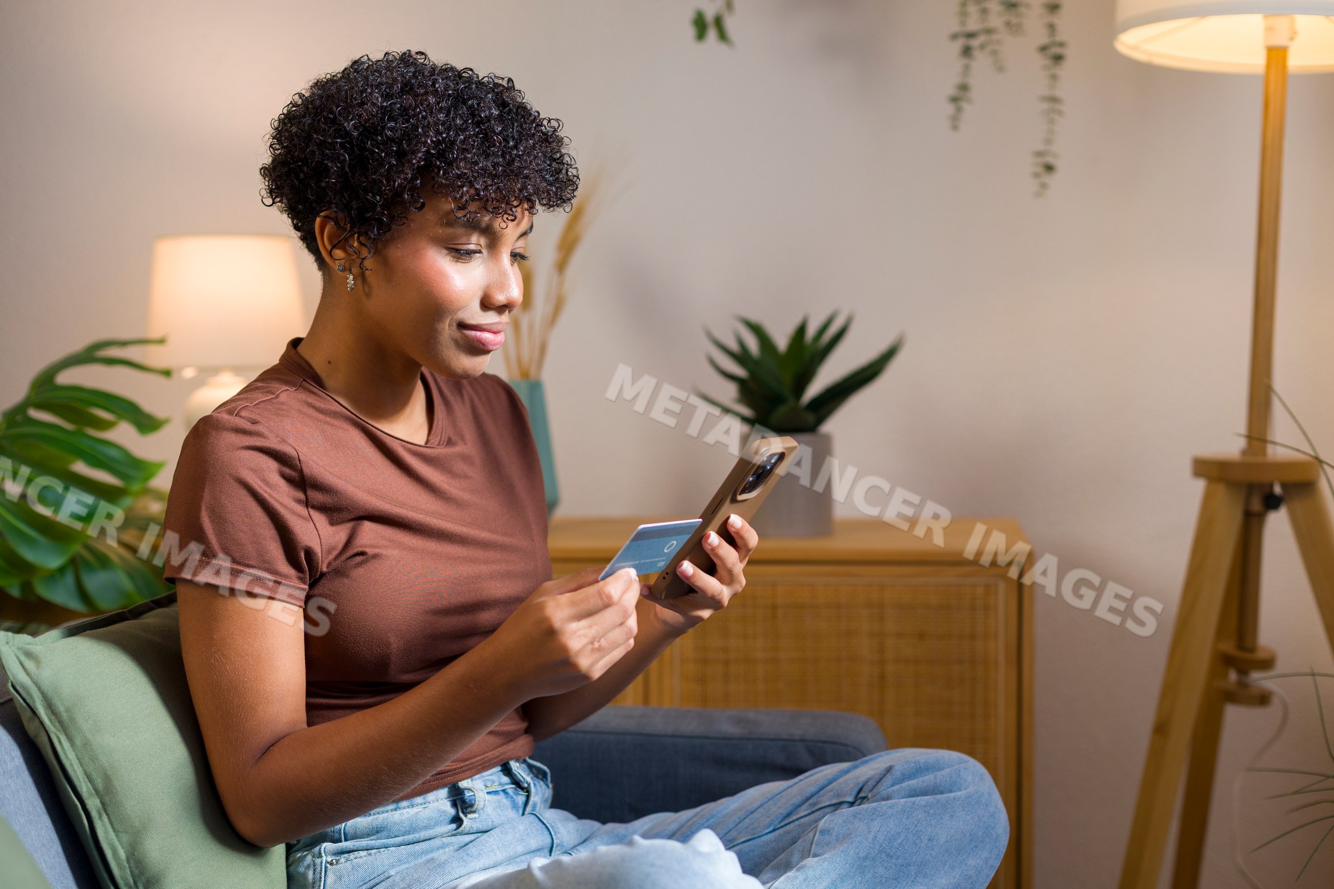 Young African American woman shopping online with credit card