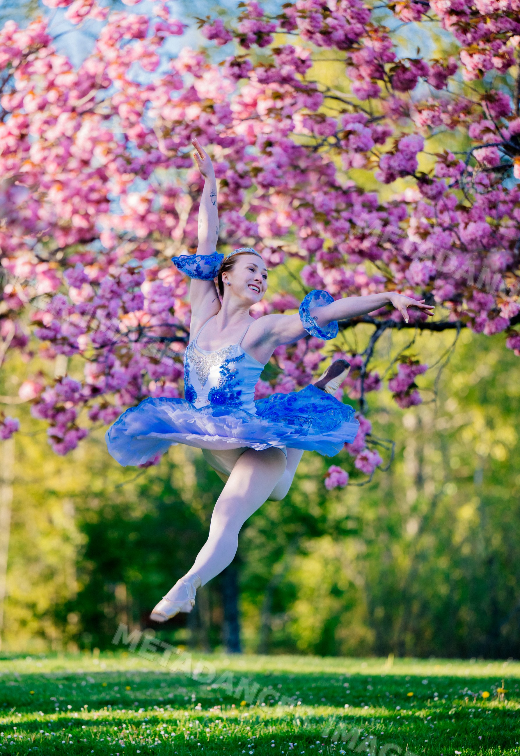 Ballerina leaps gracefully outdoors