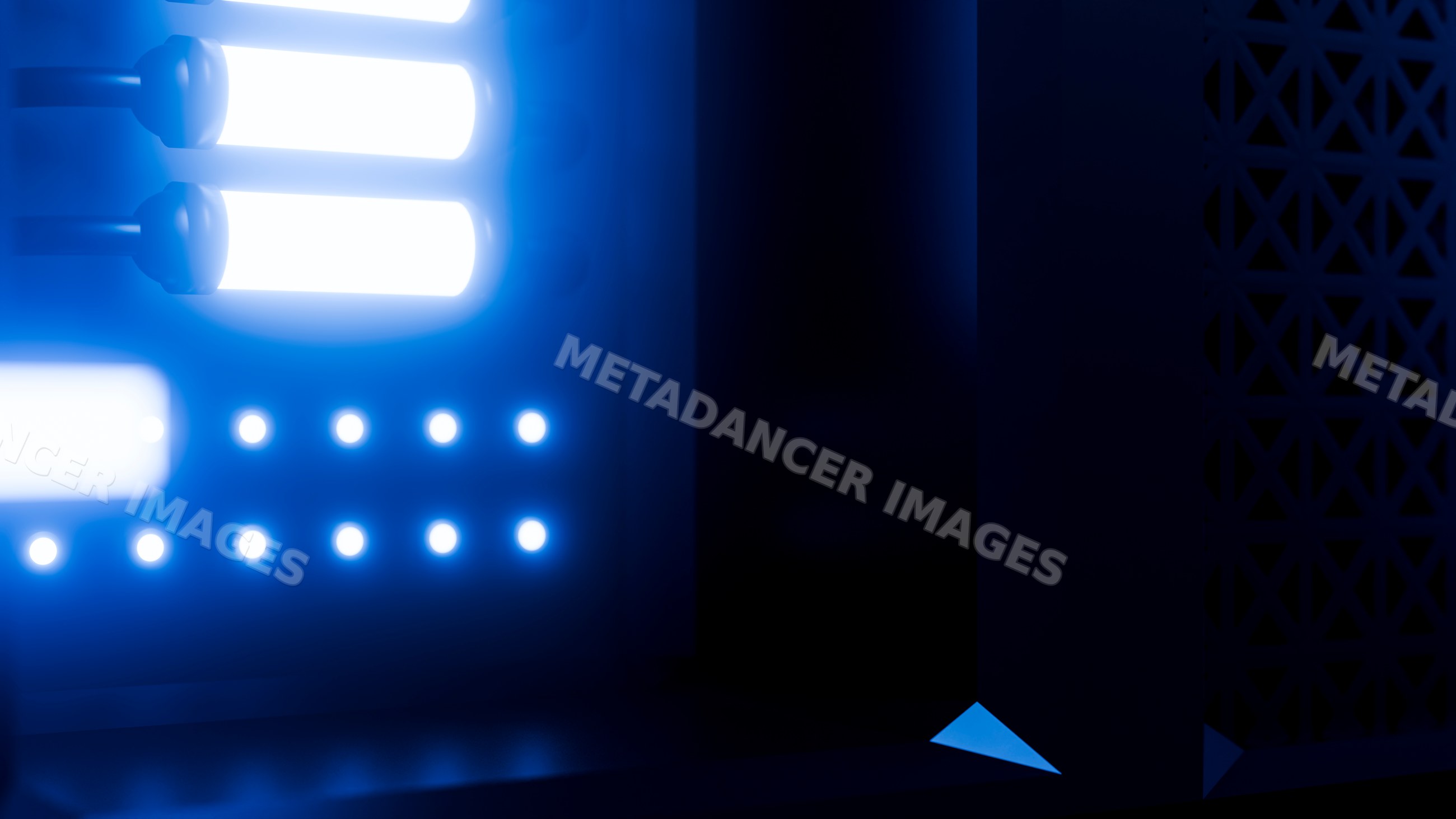 Blue led lights illuminating electronic panel with glowing tubes